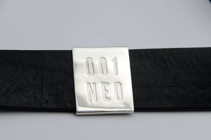 Black belt with a silver buckle labeled '001 NEO' on a light gray background